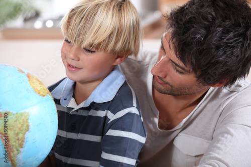 Photo: Father teaching little boy about different countries Father teaching little boy about different countries