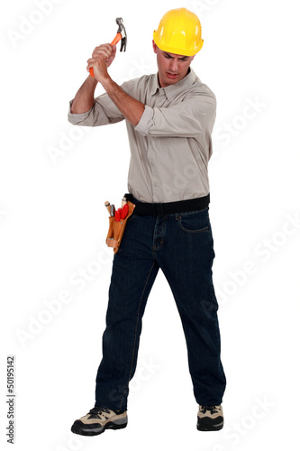 Photo: craftsman striking with a hammer craftsman striking with a hammer