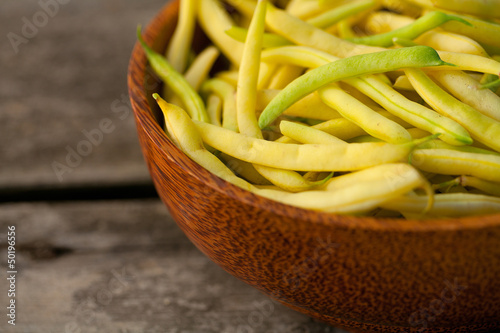 Photo: yellow kidney beans in a bowl on wooden table yellow kidney beans in a bowl on wooden table