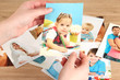Photos in hands on wooden table