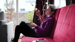 Bored woman on sofa watching tv in home