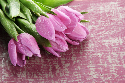 Photo: Beautiful bouquet of purple tulips on bright background Beautiful bouquet of purple tulips on bright background