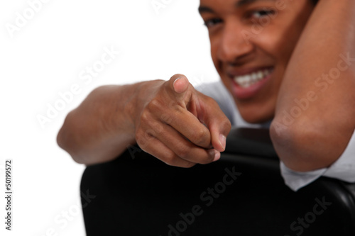 Photo: Man sitting on chair pointing Man sitting on chair pointing