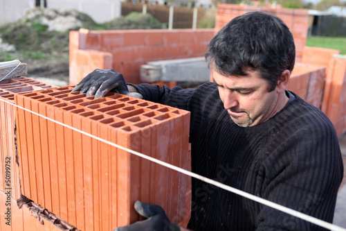 Photo: Mason laying bricks Mason laying bricks