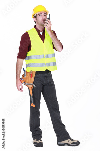 Photo: Workman using walkie-talkie on white background Workman using walkie-talkie on white background