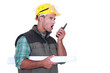 Tradesman yelling into a walkie-talkie