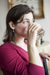 Beautiful Young Woman Drinks a Glass of Water