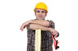 Carpenter posing with plank of wood and plane