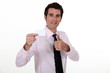 Man confidently displaying business card