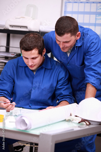 Photo: Electricians looking at a part Electricians looking at a part
