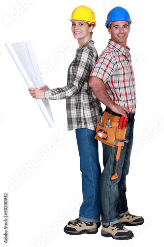 Photo: Tradespeople standing back to back Tradespeople standing back to back
