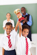 primary students holding a trophy