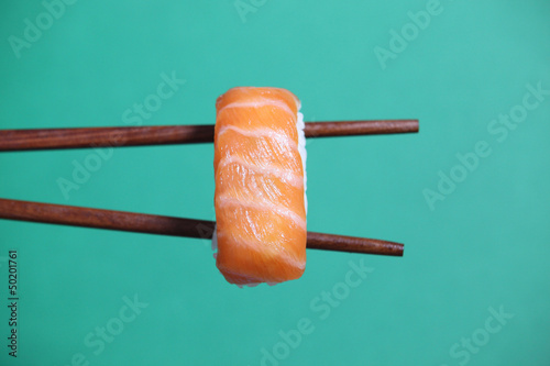 Photo: Sushi on chopsticks Sushi on chopsticks