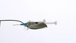 Syringe falling onto spoon of sugar