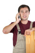 A carpenter talking on his mobile phone