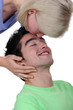 Woman kissing a man's forehead