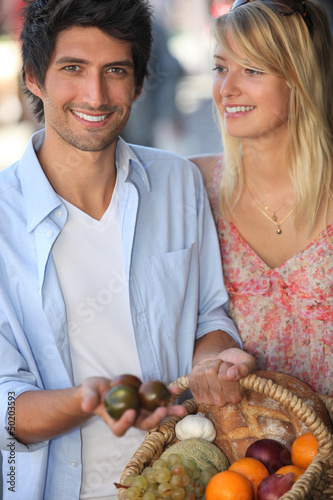Photo: Young couple choosing fruit Young couple choosing fruit