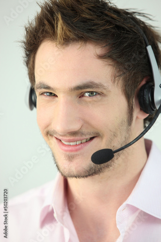 Photo: Young man wearing a headset Young man wearing a headset