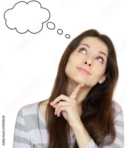 Photo: Smiling thinking girl looking up with empty bubble isolated on w Smiling thinking girl looking up with empty bubble isolated on w