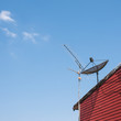 satelite is attached to the wall of the house