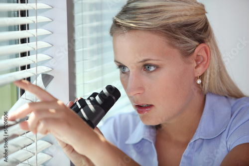 Photo: A nosy woman spying A nosy woman spying