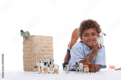 Photo: Little boy playing with plastic toy animals Little boy playing with plastic toy animals