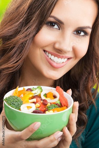 Photo: Young woman with salad, outdoors Young woman with salad, outdoors