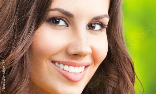 Photo: Young happy smiling woman, outdoors Young happy smiling woman, outdoors