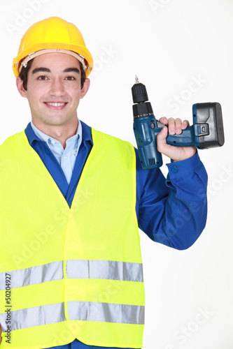 Photo: A handyman with a drill. A handyman with a drill.