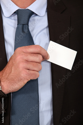 Photo: Man removing business card from pocket Man removing business card from pocket