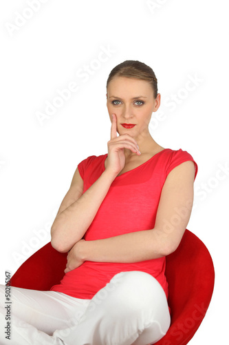 Photo: Confident woman in a red chair Confident woman in a red chair