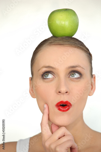Photo: woman with an apple on her head woman with an apple on her head