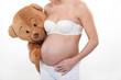 Pregnant woman with teddy bear