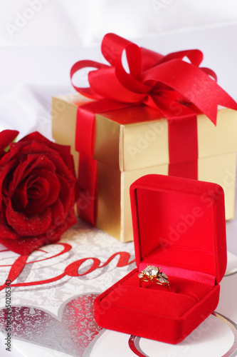 Photo: Golden diamond ring with gift box and red rose Golden diamond ring with gift box and red rose