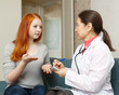 girl complaining to  doctor about symptoms