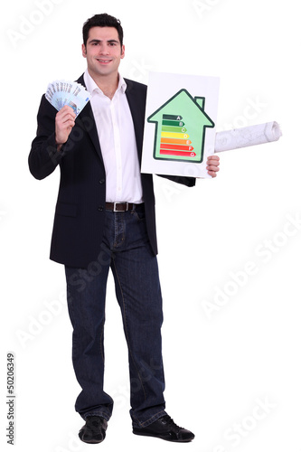 Photo: Engineer holding money and an energy efficiency rating sign Engineer holding money and an energy efficiency rating sign