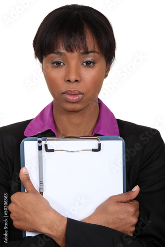 Photo: Afro-American businesswoman holding a notepad Afro-American businesswoman holding a notepad
