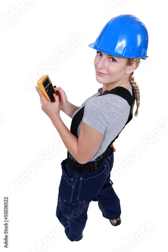 Photo: Female electrician with a voltmeter Female electrician with a voltmeter