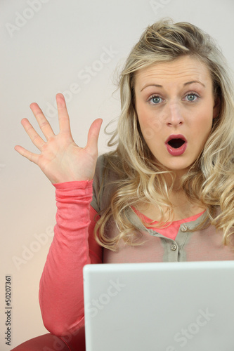 Photo: blonde woman surprised behind a computer blonde woman surprised behind a computer