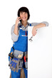Female manual worker stood with blank message board