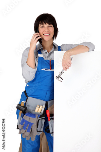 Photo: Female manual worker stood with blank message board Female manual worker stood with blank message board