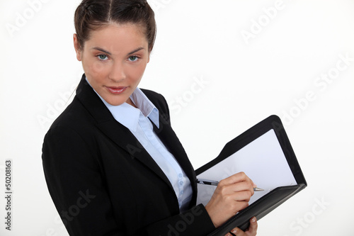 Photo: young businesswoman with agenda flirting with camera young businesswoman with agenda flirting with camera