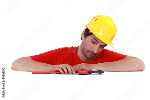 Photo: Man playing with a pipe wrench Man playing with a pipe wrench