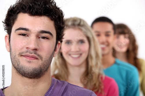 Photo: Young people standing in a row Young people standing in a row