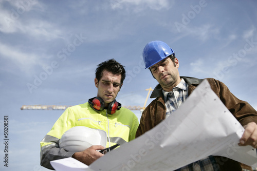 Photo: Foreman and colleague at construction site Foreman and colleague at construction site