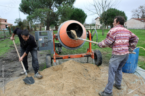 Photo: Two men mixing cement Two men mixing cement