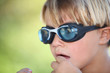 Nervous young boy wearing swimming goggles