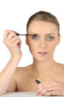 Woman putting some make-up on