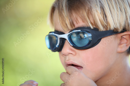Photo: Nervous young boy wearing swimming goggles Nervous young boy wearing swimming goggles