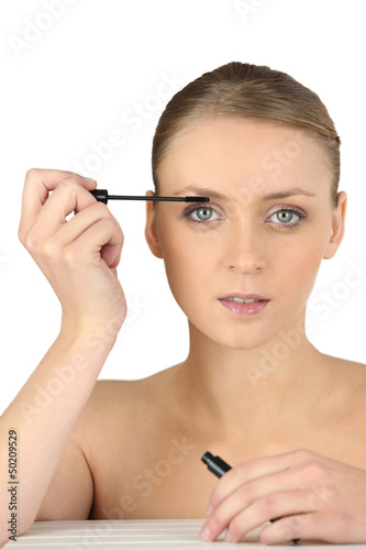 Photo: Woman putting some make-up on Woman putting some make-up on